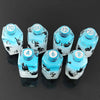 A set of seven floral resin potion bottles shaped like polyhedral dice with numbers 4, 6, 10, 12, 20, and 100.