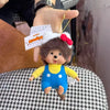 A plush monkey charm pendant featuring a brown face, yellow shirt, and blue overalls with white accents.