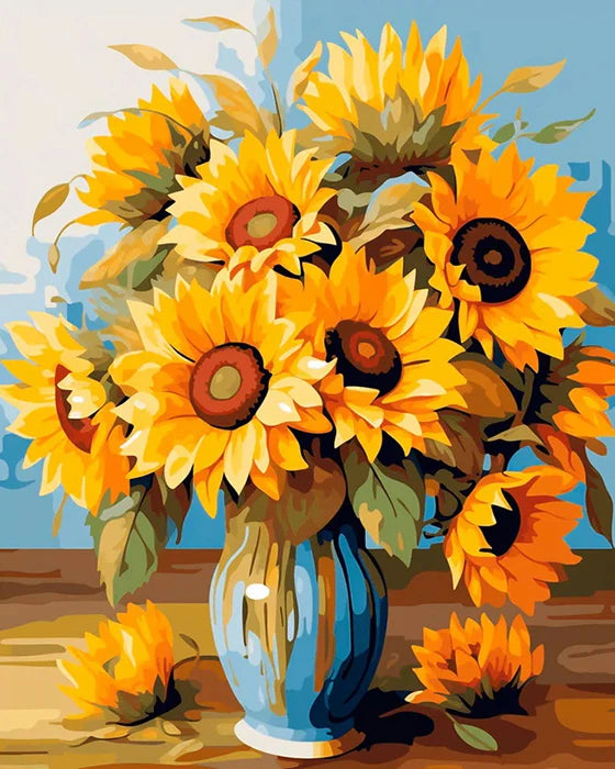 A bouquet of yellow sunflowers in a blue vase on a wooden surface.