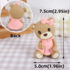 A light brown 3D bear cake topper with pink accents, shown from the back and a side view.