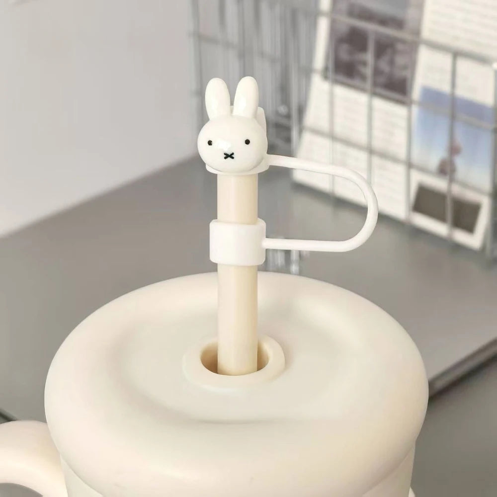 A white Miffy rabbit straw topper with a handle is shown on a light gray surface.