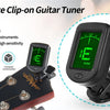 A black clip-on guitar tuner is shown mounted on a guitar neck, demonstrating its use for tuning instruments.