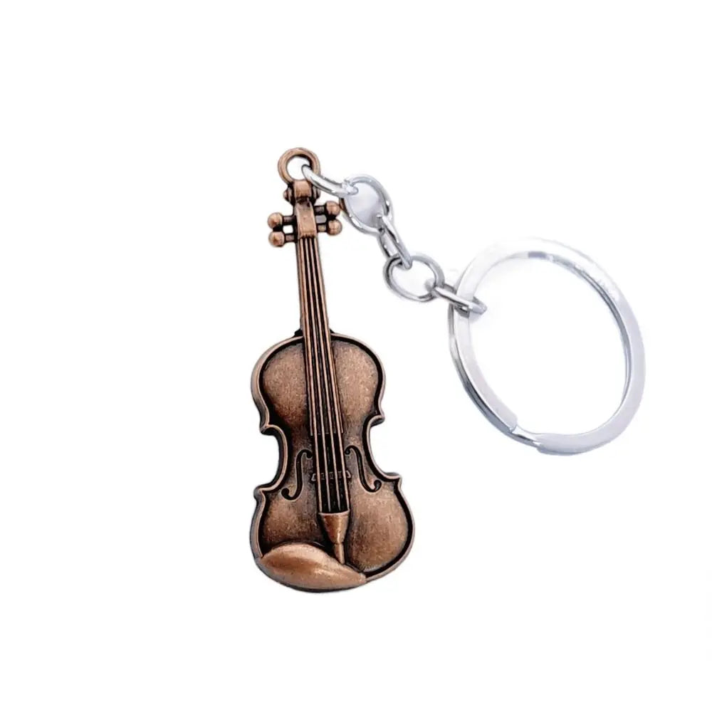 A vintage brown violin charm attached to a silver keychain ring.