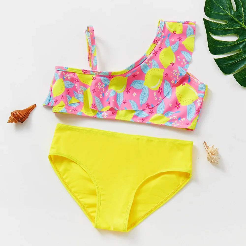A girls two-piece rainbow swimsuit set featuring pink and yellow floral patterns.