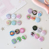 A collection of colorful kawaii mini pin badges featuring various designs and patterns on a white surface.