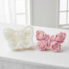 Two silicone molds shaped like pink and white roses forming a butterfly for candle and DIY crafts