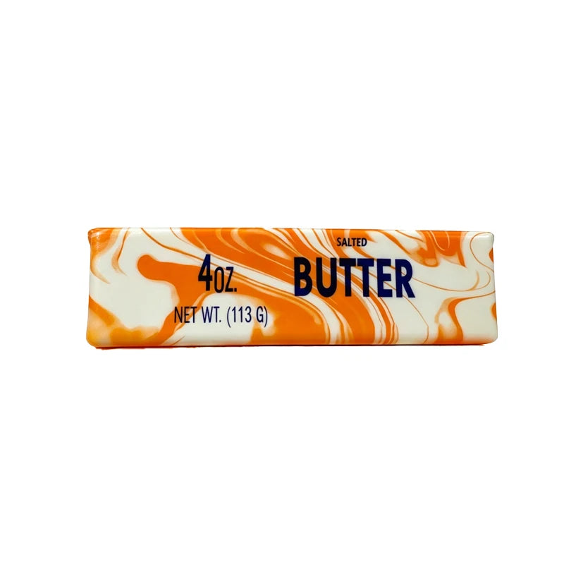A rectangular bar of salted butter squishy stress relief toy with an orange and white marbled pattern.