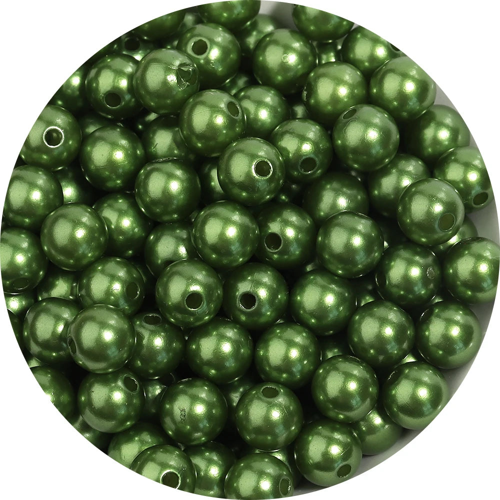 A pile of green imitation pearl beads used for DIY jewelry making.