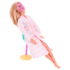 A blonde doll wearing a pink coat and a pink mask is shown with a cleaning accessory stand.