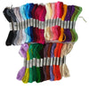 A collection of multicolor embroidery floss skeins in various shades including black, blue, pink, green, and yellow.