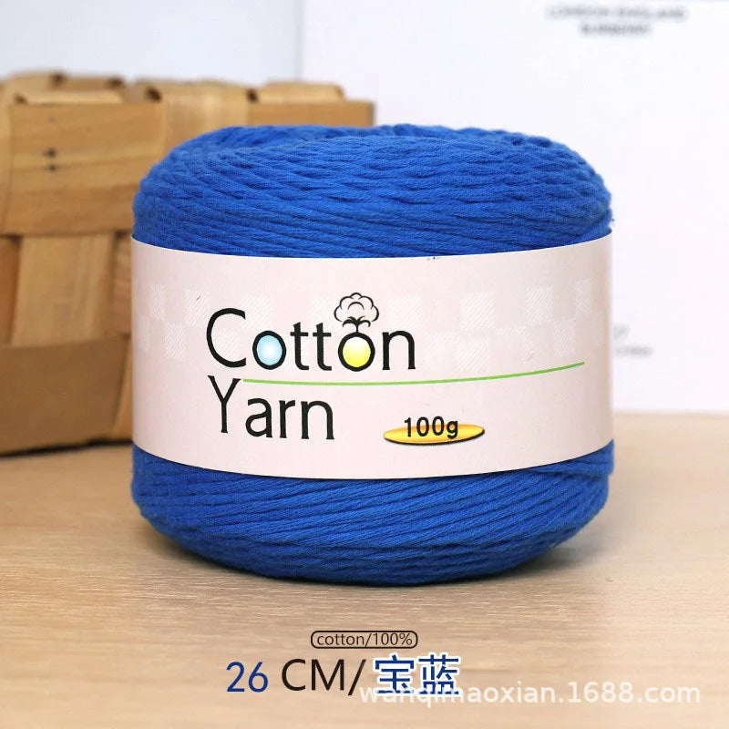 A ball of blue 100% cotton yarn labeled Cotton Yarn with a 100g weight.