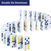 A collection of double six domino tiles in various colors and patterns laid out for a game.