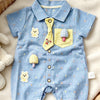 A light blue baby boy short-sleeve romper with yellow and white bear and mushroom appliqués
