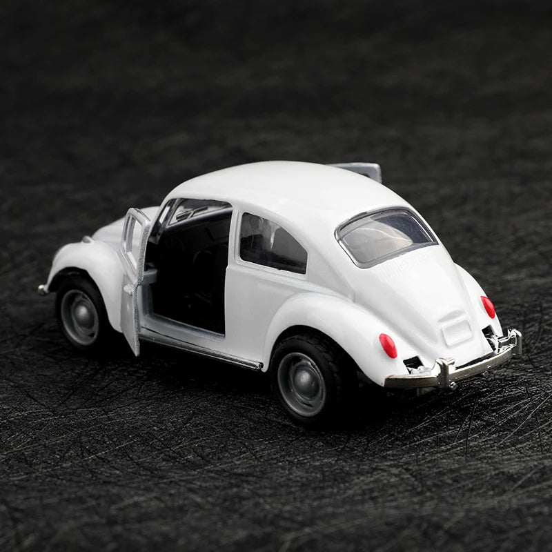 A white 1:38 die-cast model of a classic Beetle car shown from the side against a dark background.