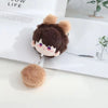 A fluffy brown plush pendant keychain featuring a cute, stylized character face.