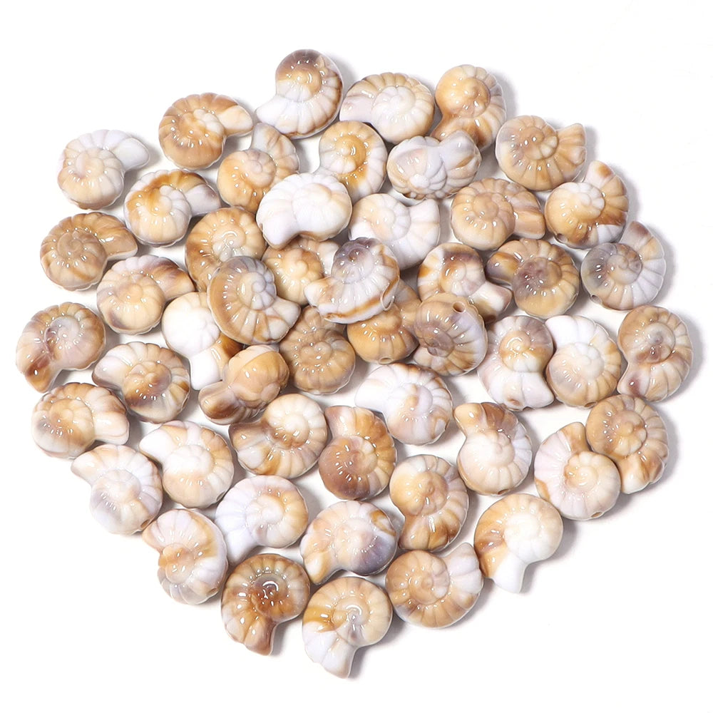 A variety pack of acrylic beads shaped like starfish, conch, and turtle in natural beige and white tones.