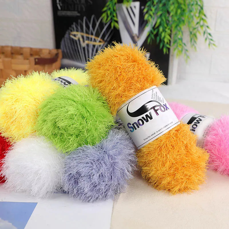 A collection of bright yellow, green, purple, and orange chunky faux fur yarn balls.