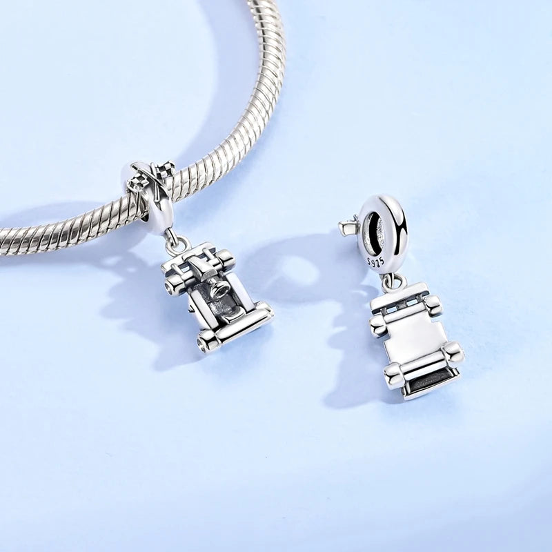Sterling silver charm bead pendant featuring a car, key, and other charms on a silver chain.