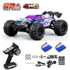 A brushless 4WD monster truck RC car with purple and blue body, black tires, and accessories.
