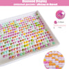A display of various colored and clear rhinestones arranged in rows on a white tray.
