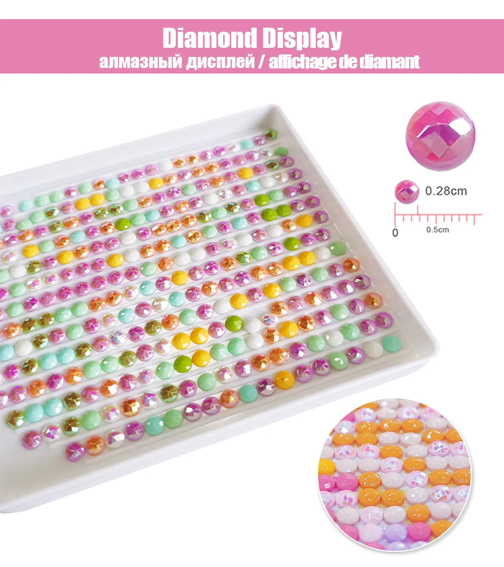 A display of various colored and clear rhinestones arranged in rows on a white tray.