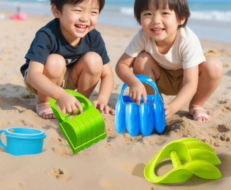 Three happy toddlers playing with green and blue dinosaur claw sand digging toys on a sandy beach.