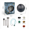A box containing a planet model and various stones like black stone, white granite, green agate, and tiger eye stone.
