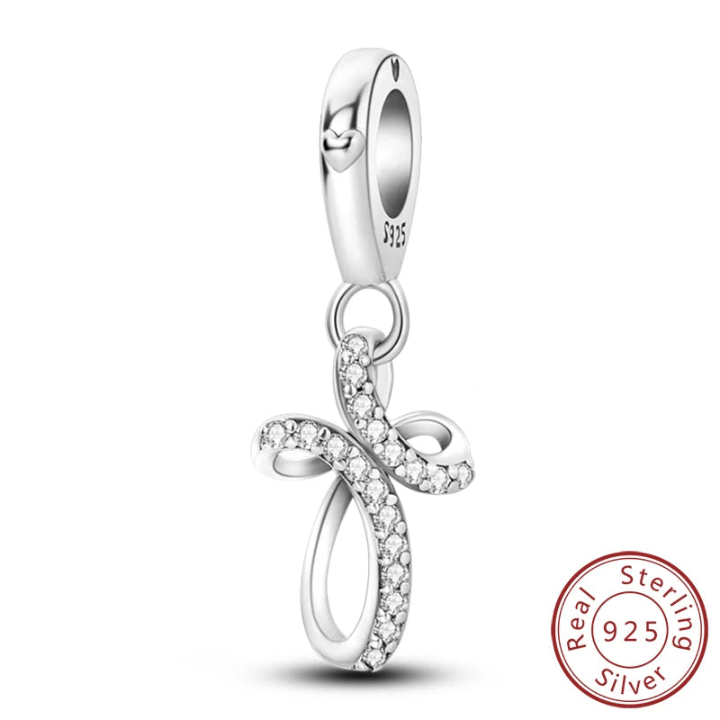 Sterling silver charm beads set featuring cross, angel, and evil eye designs for DIY jewelry making