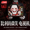 A detailed model building set of a horror movie puppet featuring a white mask and red accents, held by a person.
