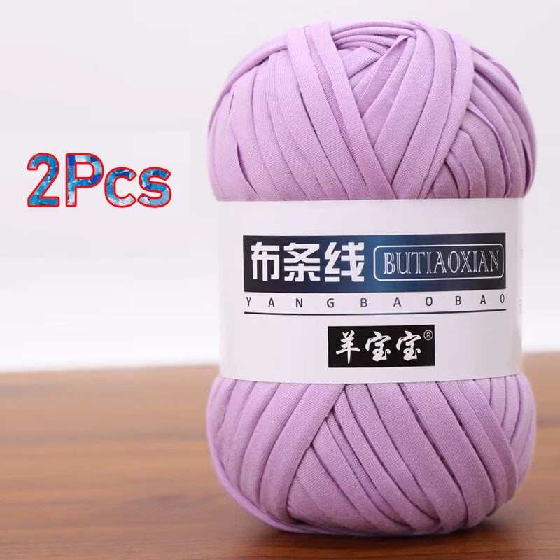 A skein of purple soft chunky t-shirt yarn for crochet and knitting, packaged as a 2-pack.