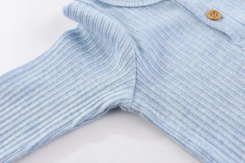 Light blue cotton baby bodysuit with long sleeves shown flat lay