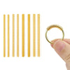 A set of ten gold-colored ring size adjusters arranged in a row, shown next to a hand holding one adjuster.