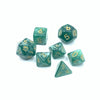 A set of seven green polyhedral dice, including a d6 and d10, scattered on a white background.