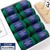 A box containing ten balls of bright green YEDAN MERIN worsted wool thread yarn for knitting projects.