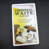 A deck of Universal Waite Tarot cards featuring drawings by Pamela Colman Smith and a guide book.