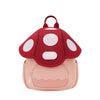 A pink mini backpack with a red mushroom print featuring white polka dots.