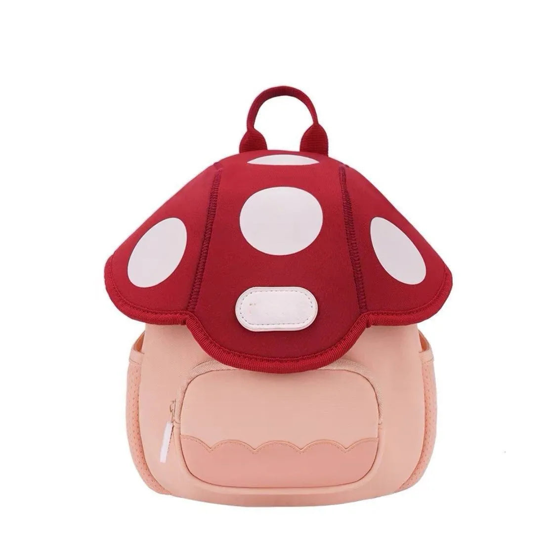 A pink mini backpack with a red mushroom print featuring white polka dots.
