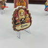 A creative 3D refrigerator magnet featuring a group of women in traditional Russian-inspired attire with the word Russia.