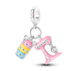 A silver heart charm bead with a pink zircon and a dangling bracelet.