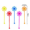 A collection of colorful, translucent party favor toys shaped like spider webs on sticks.