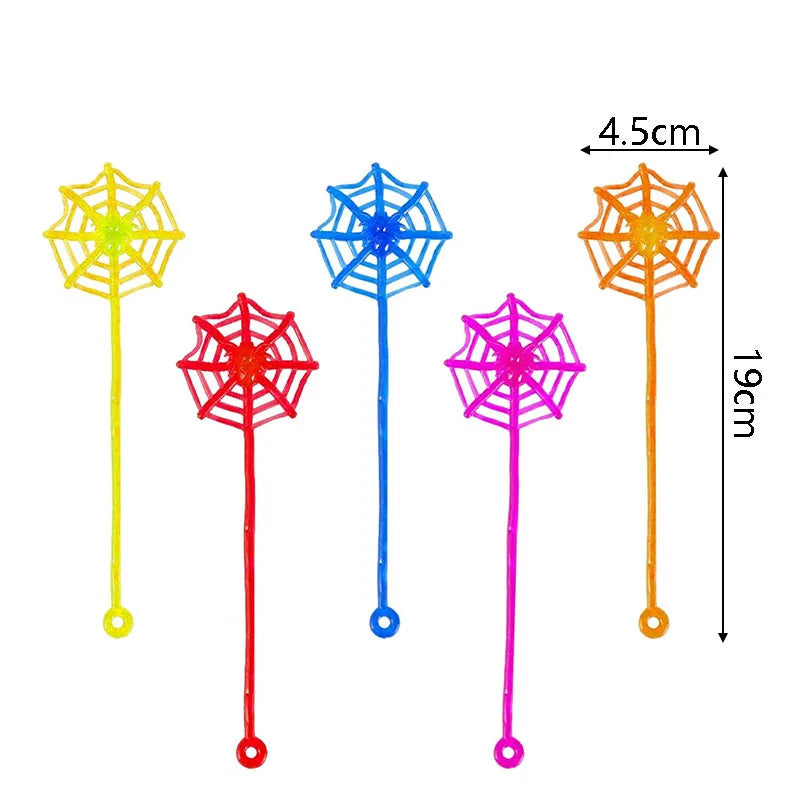 A collection of colorful, translucent party favor toys shaped like spider webs on sticks.