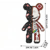 A 3D bear building kit made of black and white micro diamond blocks with pink accents.