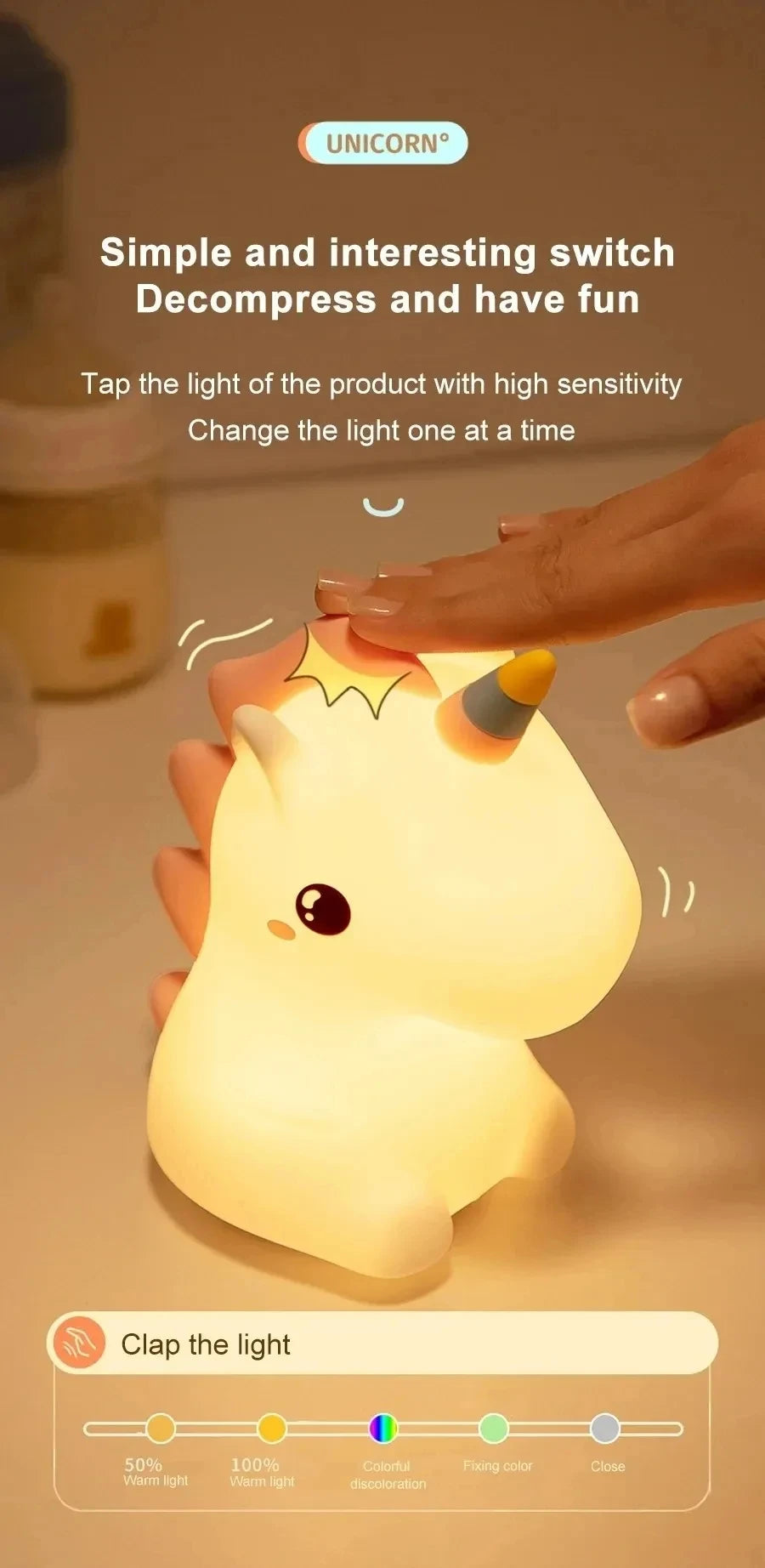 A hand is tapping a cute unicorn silicone LED night light, which illuminates with a warm light.