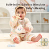 A baby is holding a silicone teether set for babies, which includes a rattle and chew toys.