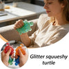 A woman holds a glitter squishy turtle toy in her hand.