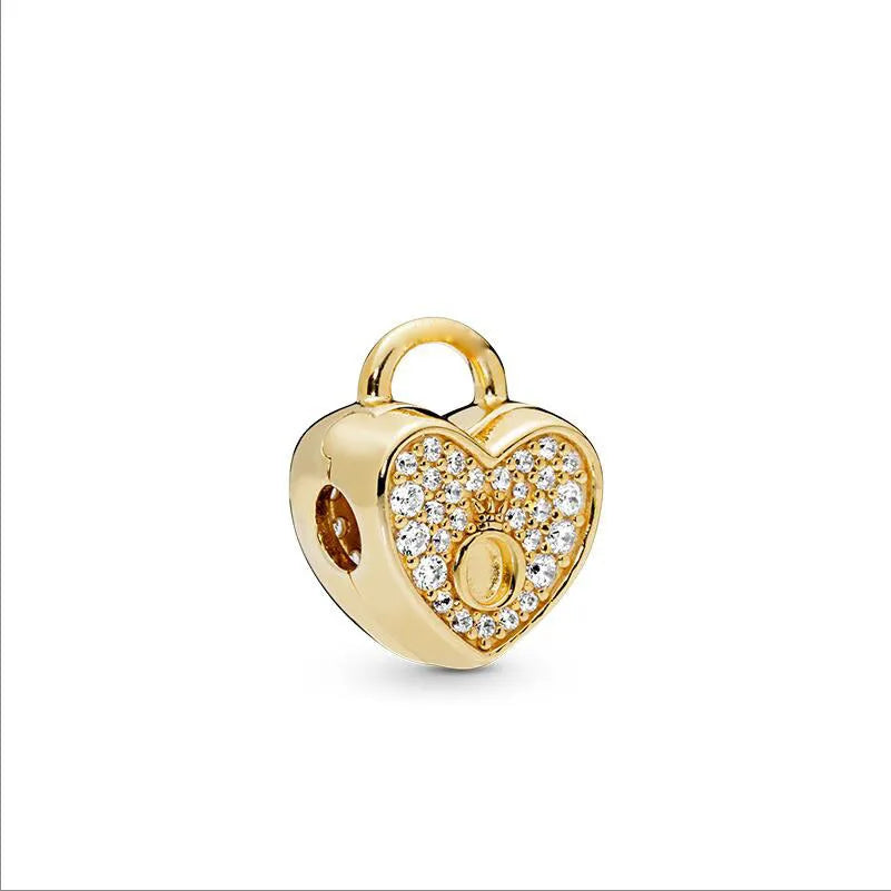 Gold charm bracelet featuring elephant, key, butterfly, and heart pendants.