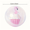 A pink miniature figure of a swan in a cupcake wrapper on a clear plastic disc.