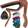 A wooden guitar capo holder with a 7-piece set of guitar picks and a protective cap.