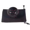 A black 100-sided polyhedral die resting in a dark brown storage bag.