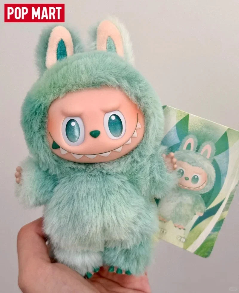 A soft mint green Labubu vinyl plush pendant featuring large ears and a smiling expression.
